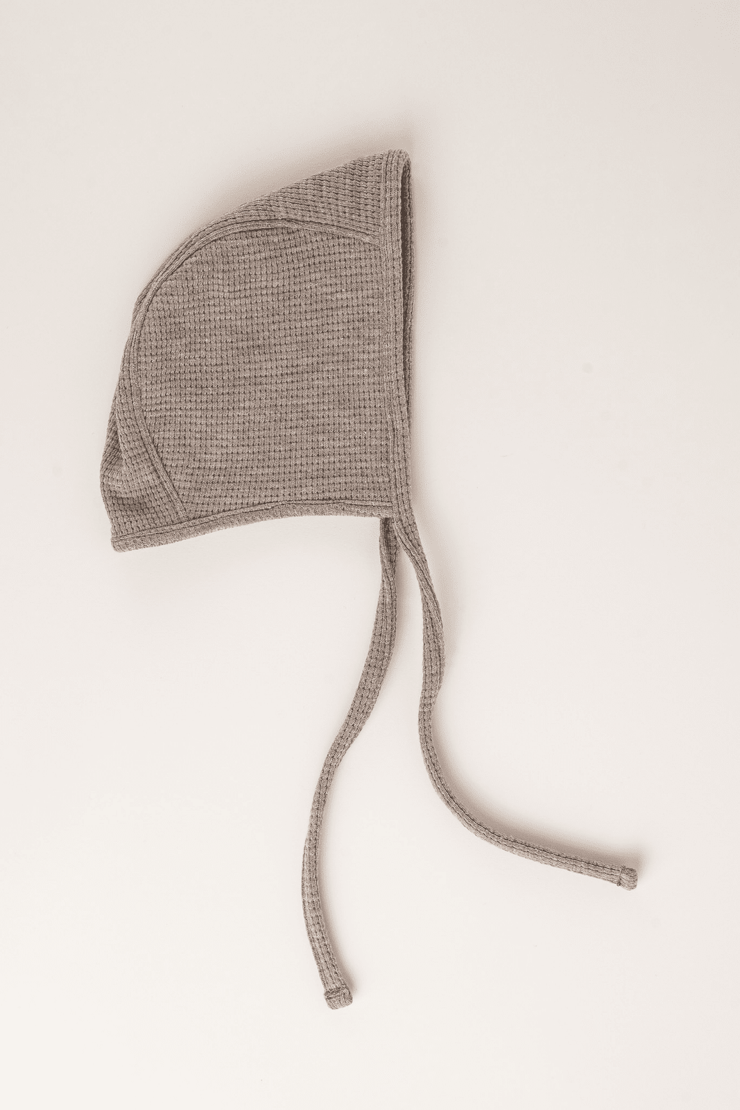 Beige knitted baby bonnet