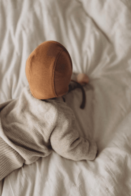 Knitted baby bonnet caramel