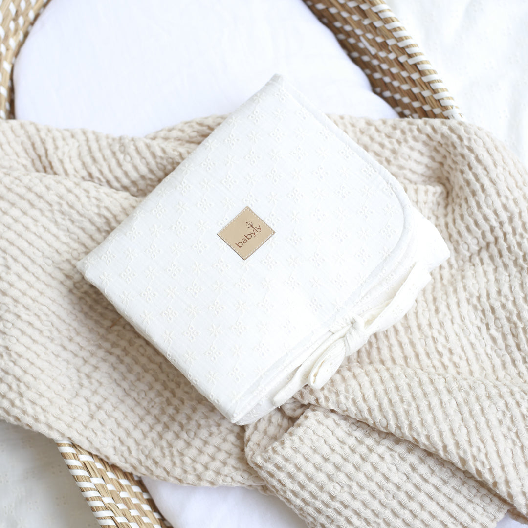 Pink embroidered muslin changing table
