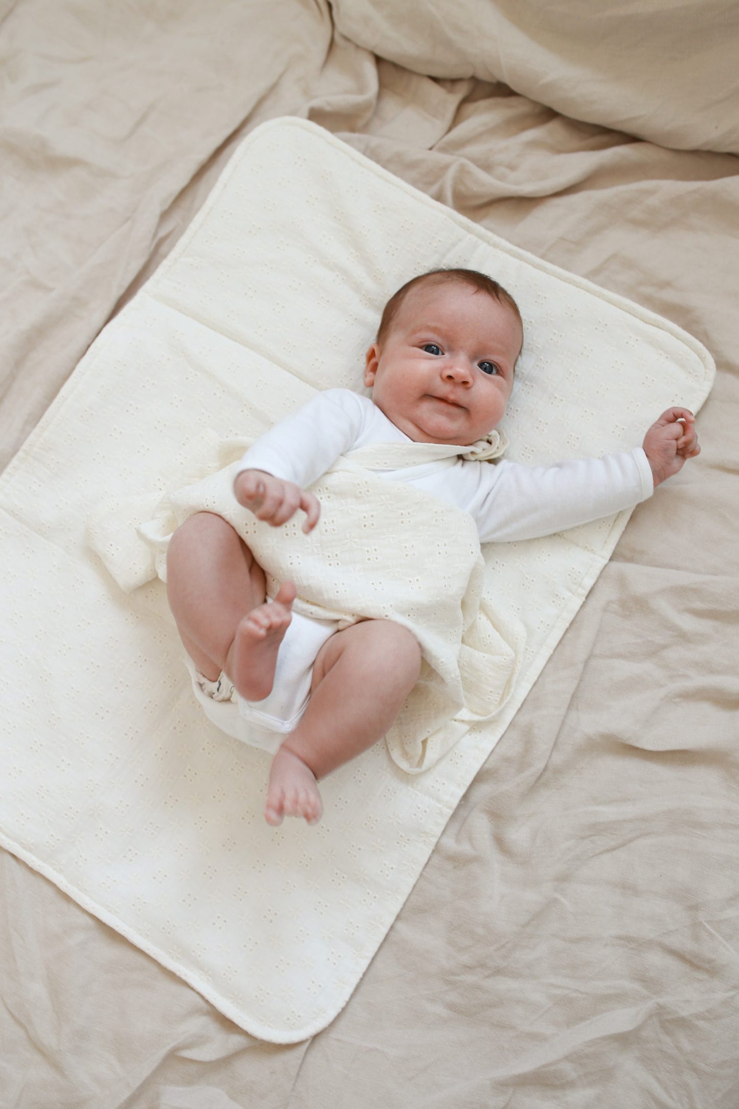 Pink embroidered muslin changing table