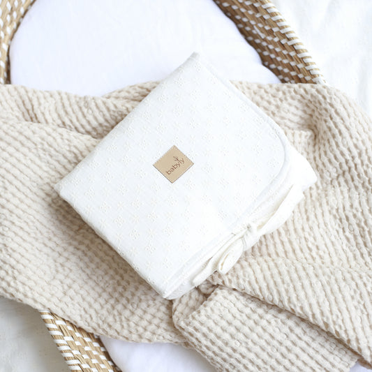Raw embroidered muslin changing table
